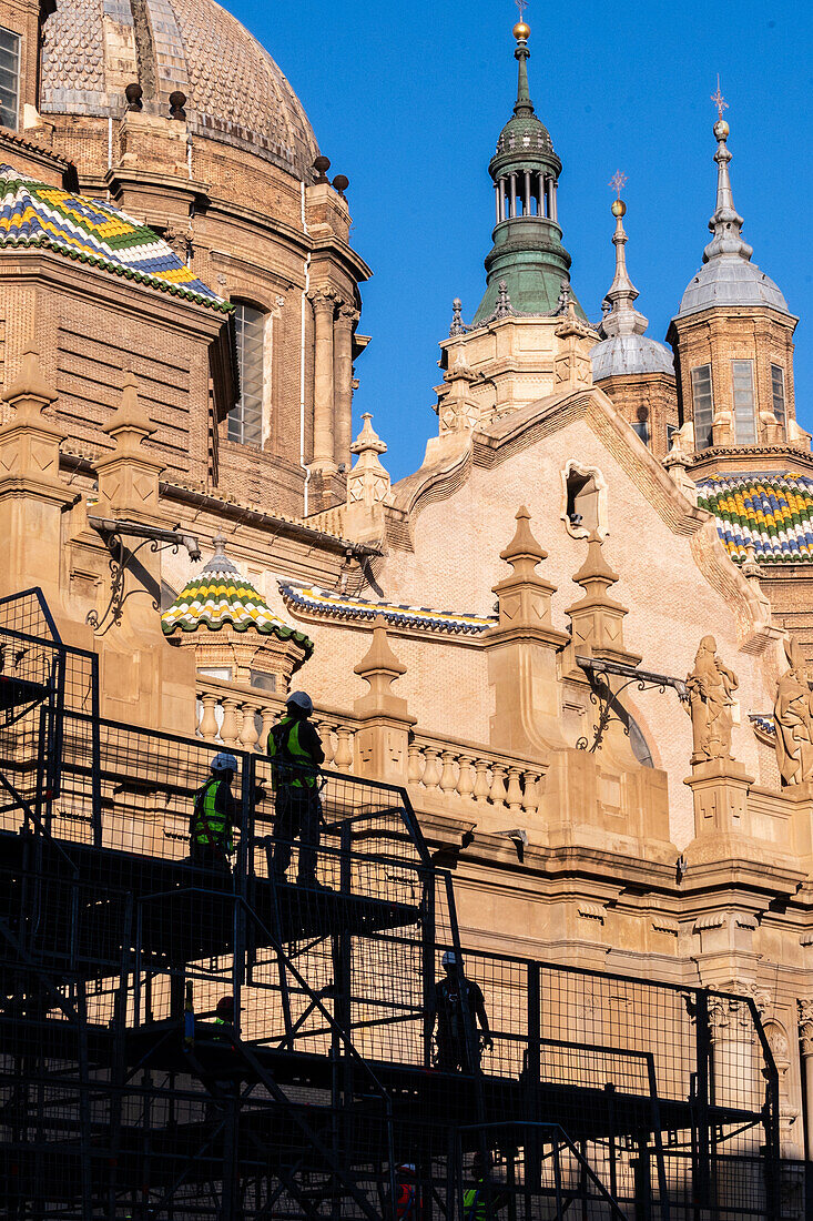Workers preparing the platform for The Offering of Flowers to the Virgen del Pilar, the most important and popular event of the Fiestas del Pilar held on Hispanic Day, Zaragoza, Spain\n