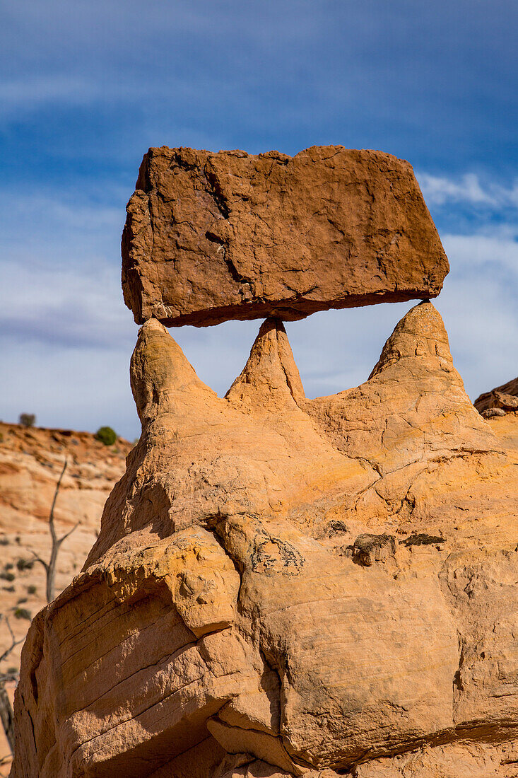 A sandstone block left balanced by erosion in the Orange Cliffs of the Glen Canyon National Recreation Area in Utah.\n