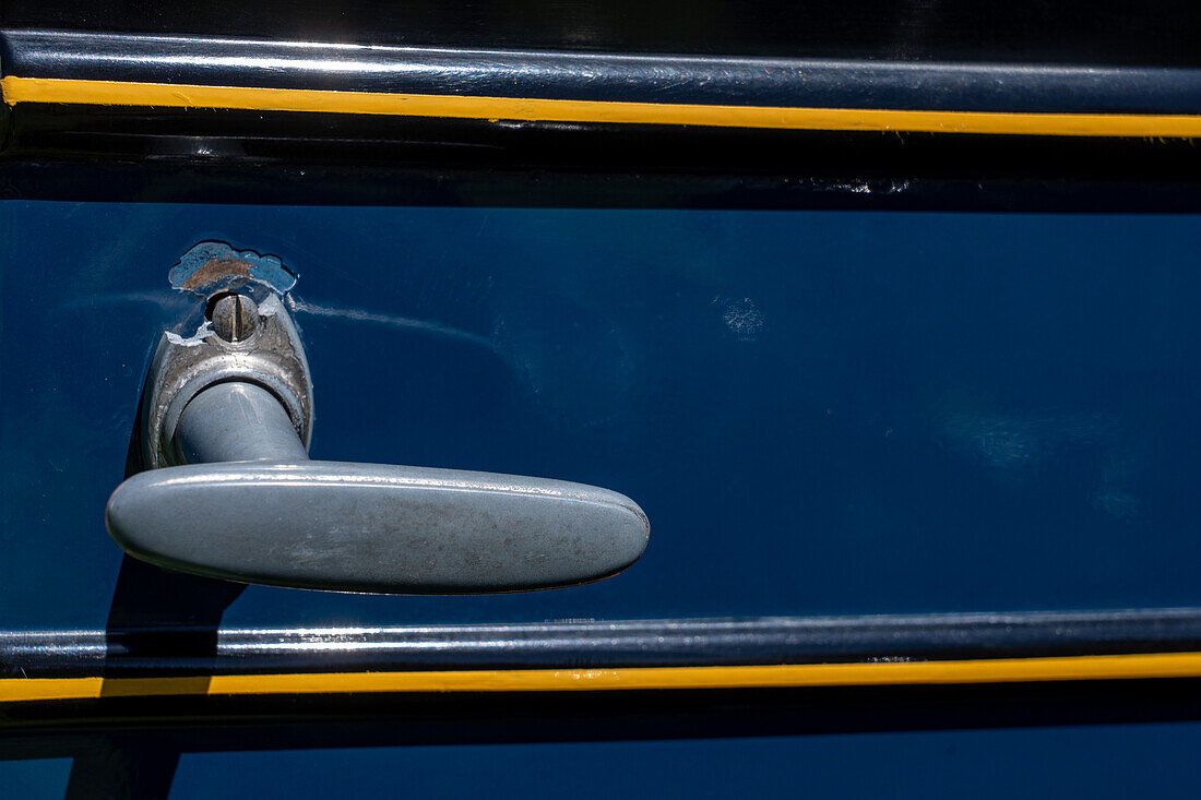 Detail of the original door handle a restored vintage 1927 Chevrolet Series AA Capitol sedan in a car show in Moab, Utah.\n