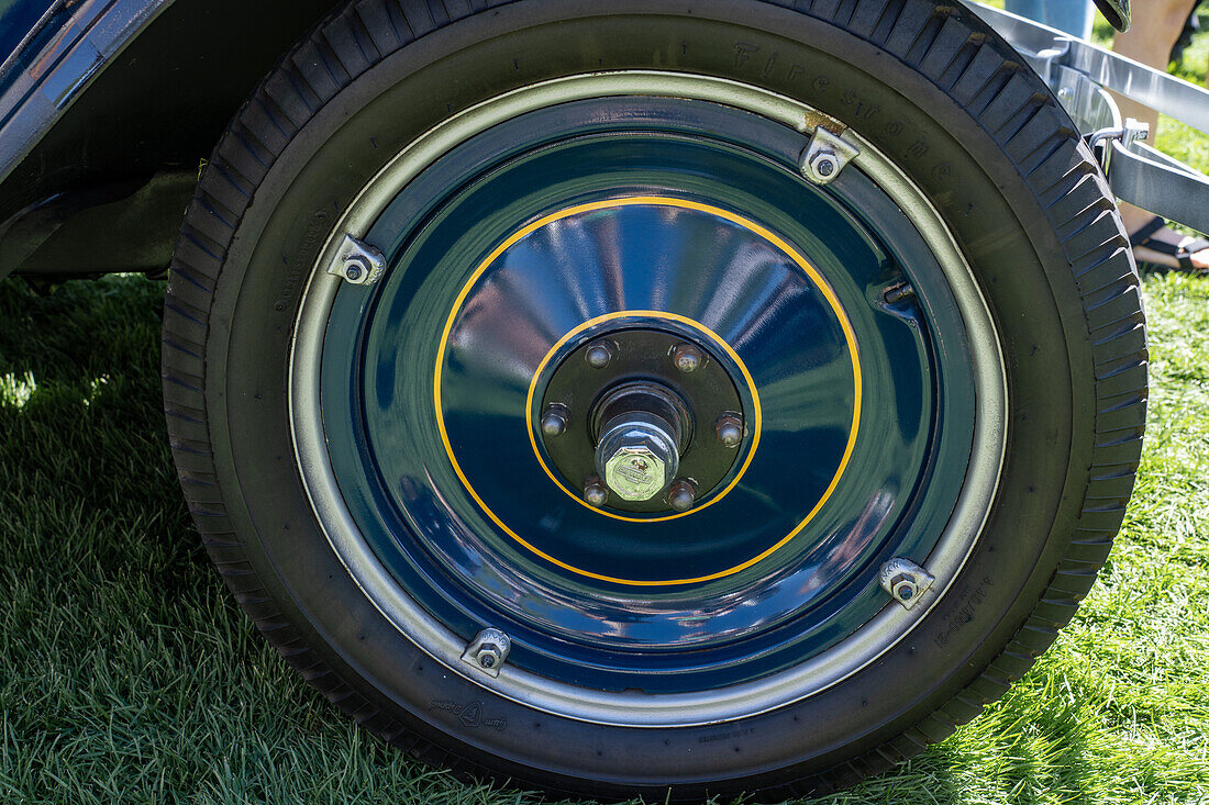 Detail of the pinstriped wheel on a restored vintage 1927 Chevrolet Series AA Capitol sedan in a car show in Moab, Utah.\n