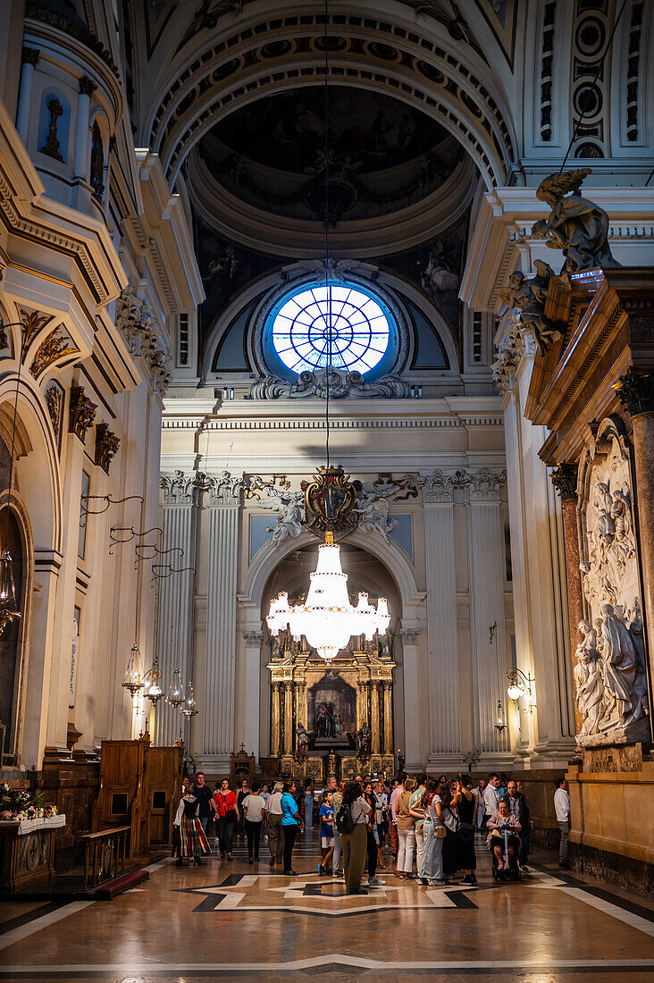 Believers inside the Cathedral-Basilica of Our Lady of the Pillar during The Offering of Flowers to the Virgen del Pilar, the most important and popular event of the Fiestas del Pilar held on Hispanic Day, Zaragoza, Spain\n