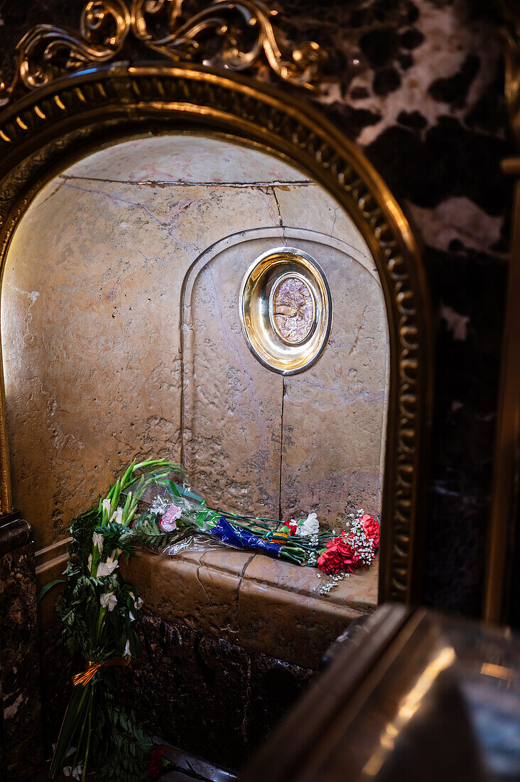 Worshipers kiss this pillar inside the Cathedral-Basilica of Our Lady of the Pillar during The Offering of Flowers to the Virgen del Pilar, the most important and popular event of the Fiestas del Pilar held on Hispanic Day, Zaragoza, Spain\n