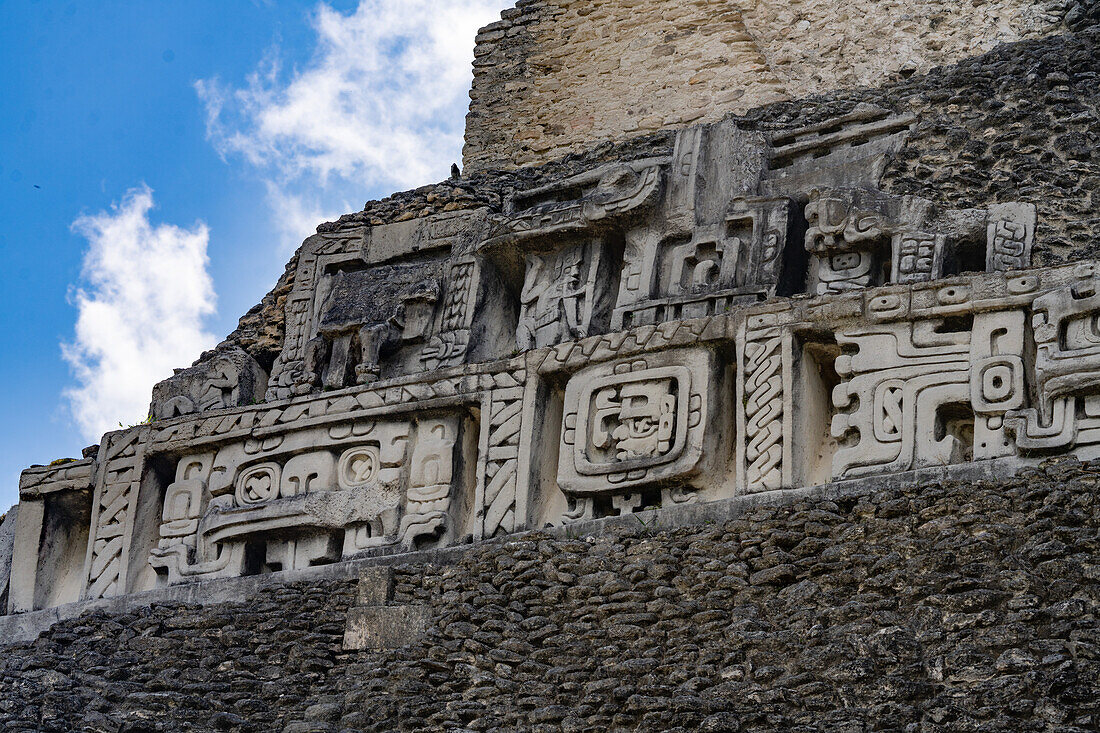 The west frieze on El Castillo or Structure A-6 in the Mayan ruins of the Xunantunich Archeological Reserve in Belize. The center figure is identified as Kawil, an ancestral deity.\n