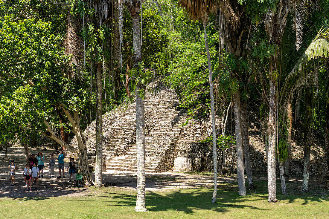 Tourists in front of Structure A-9 in the Mayan ruins in the Xunantunich Archeological Reserve in Belize.\n