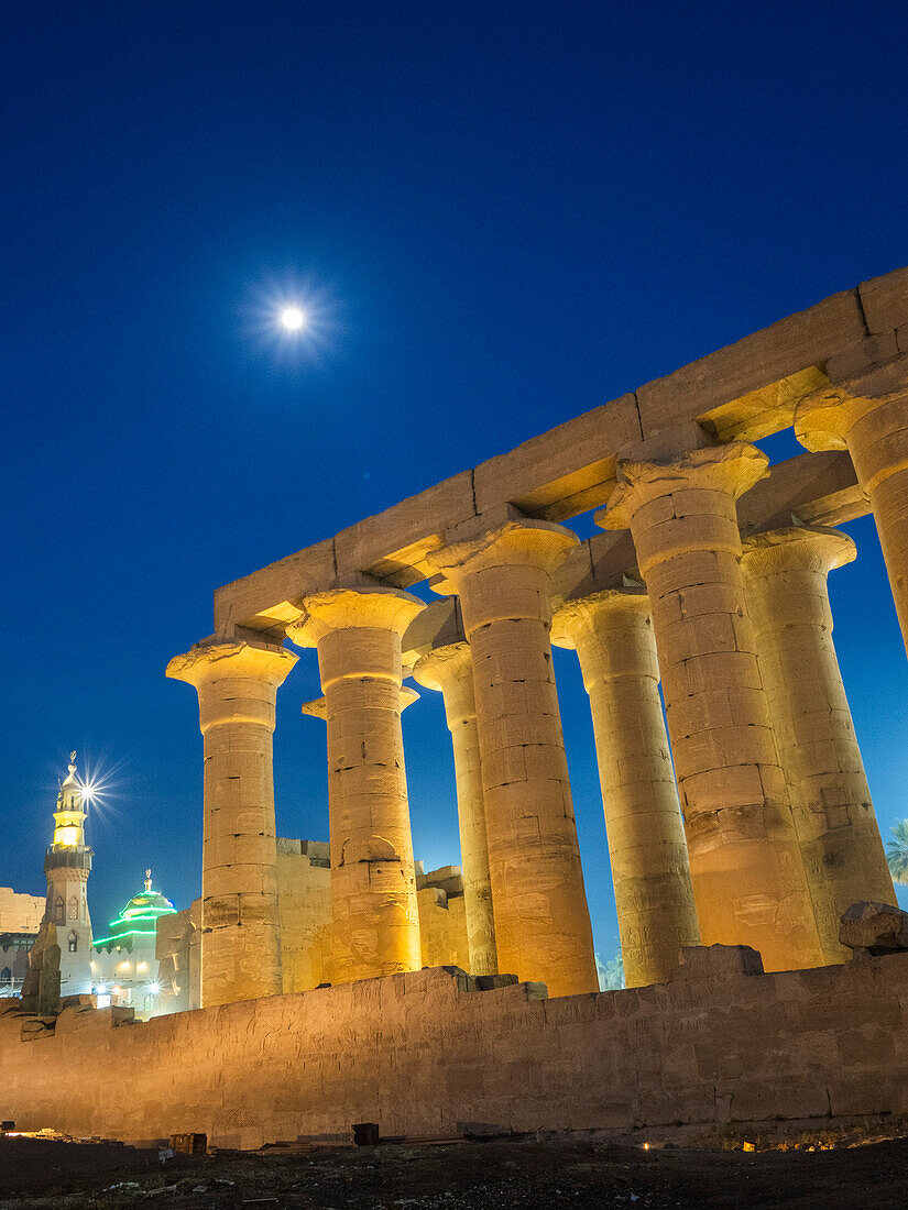 The Luxor Temple at night, under a full moon, constructed approximately 1400 BCE, UNESCO World Heritage Site, Luxor, Thebes, Egypt, North Africa, Africa\n