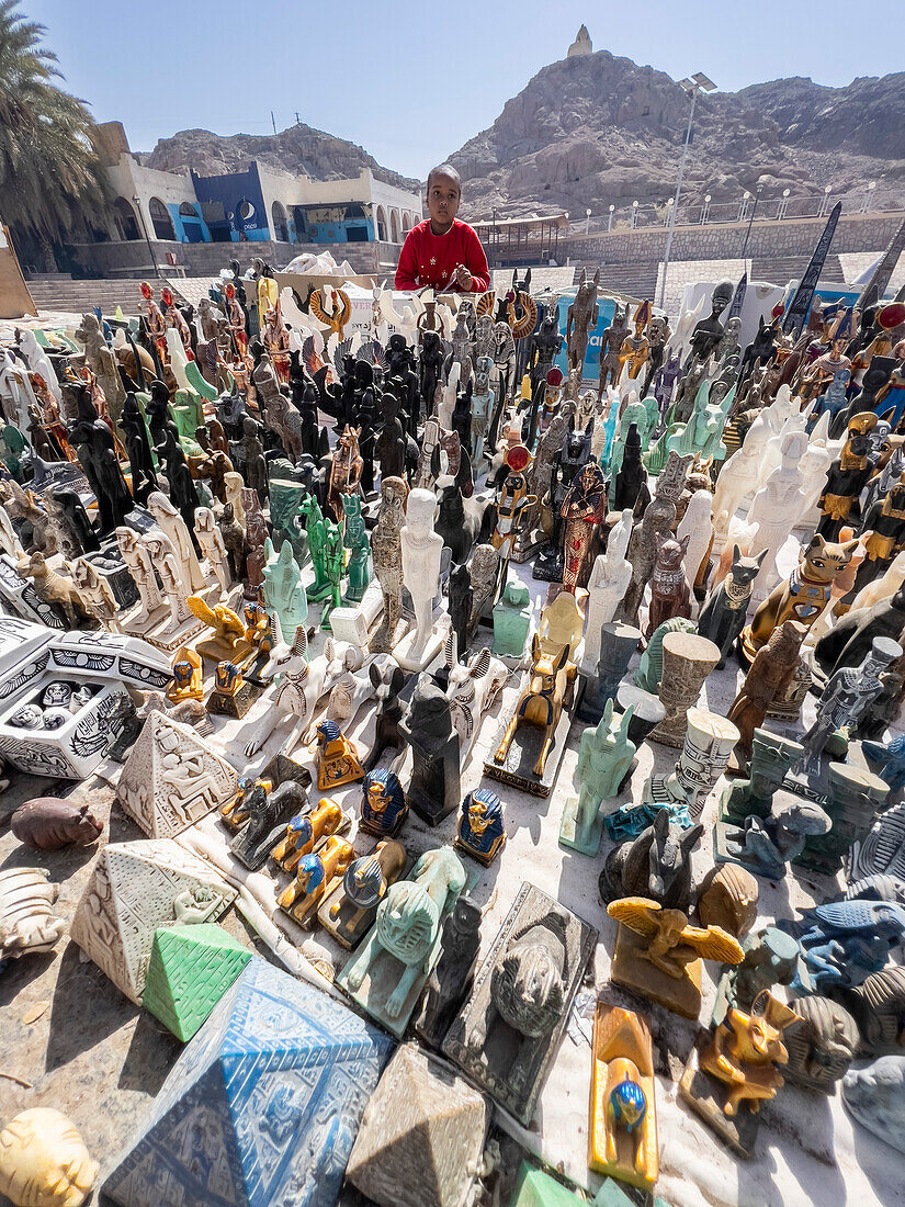 Egyptian vendor outside the Philae temple complex, The Temple of Isis, currently on the island of Agilkia, Egypt, North Africa, Africa\n