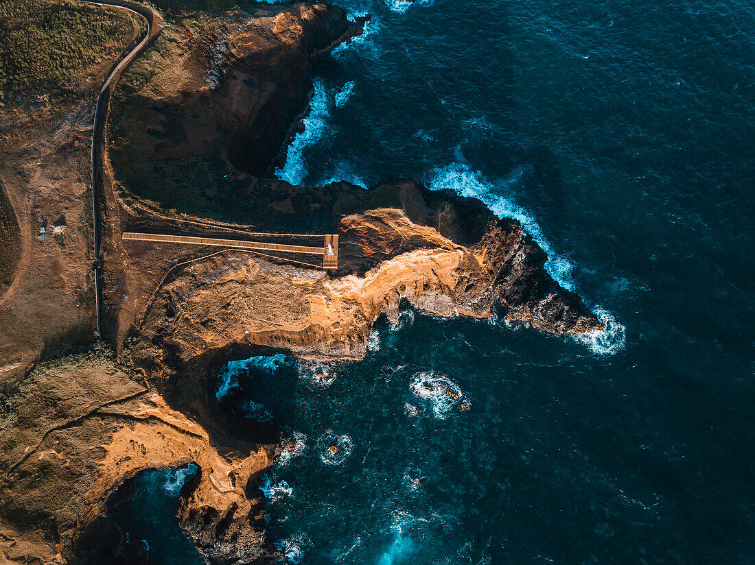 Aerial view of the coasts and cliffs of the island of Sao Miguel over the lighthouse of Farolim dos Fenais da Ajuda, Azores Islands, Portugal, Atlantic, Europe\n