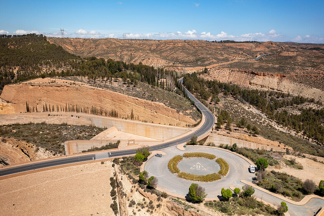 Drone aerial view of a helicopter landing parking on a desert like landscape near Francisco Abellan Dam and Reservoir, Granada, Andalusia, Spain, Europe\n