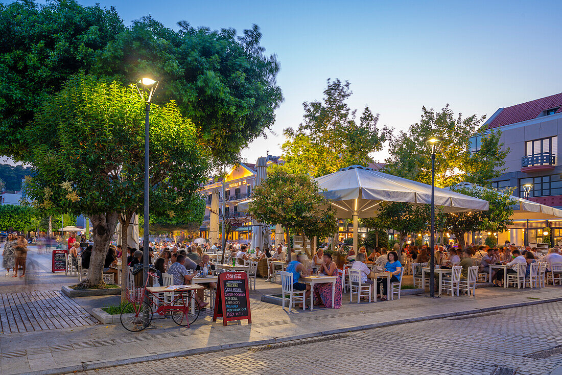 View of restaurant in Vallianou Square at dusk, capital of Cephalonia, Argostolion, Kefalonia, Ionian Islands, Greek Islands, Greece, Europe\n