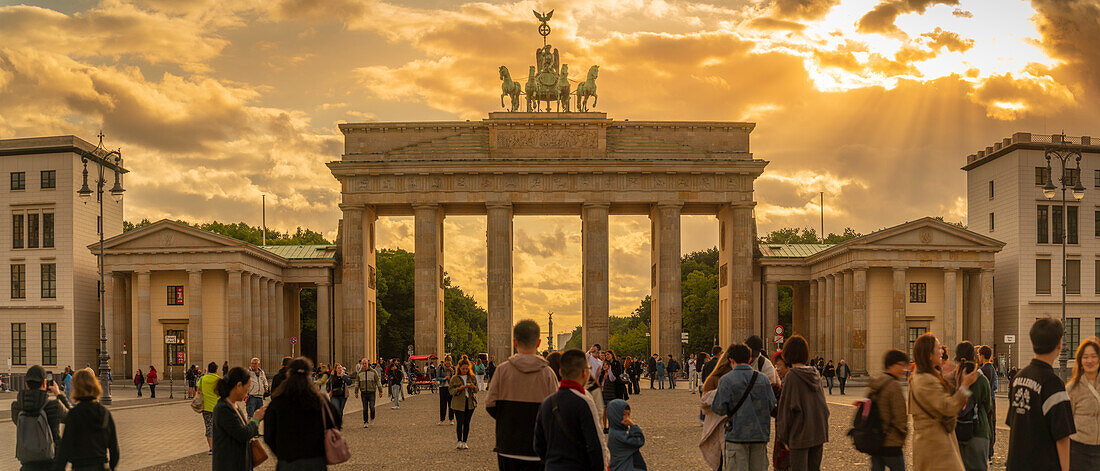 View of people gathered at Brandenburg Gate at sunset, Pariser Square, Unter den Linden, Berlin, Germany, Europe\n