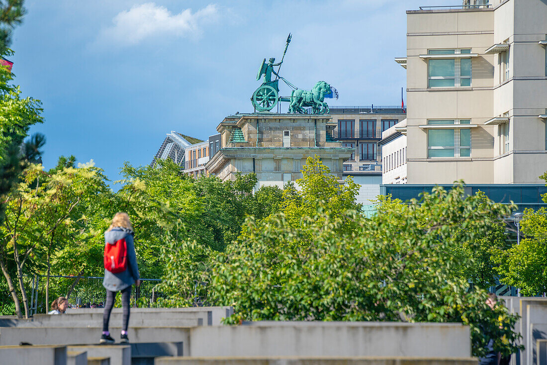 View of woman viewing Brandenburg Gate (Brandenburger Tor), Mitte, Berlin, Germany, Europe\n