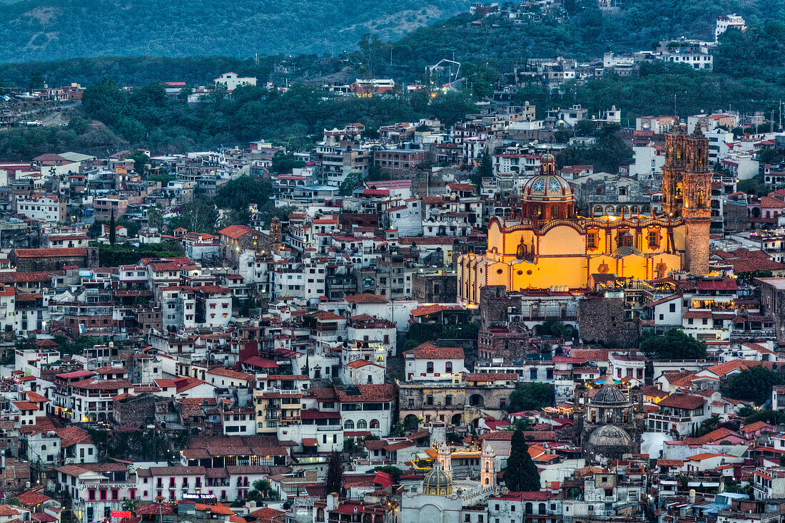 Evening overview, with illuminated Church of Santa Prisca de Taxco, Taxco, Guerrero, Mexico, North America\n