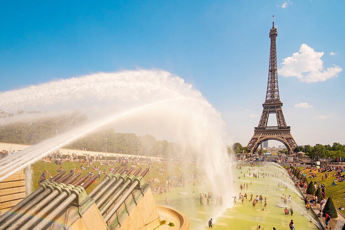 France, Paris, area listed as World Heritage by UNESCO, the Trocadero gardens in front of the Eiffel Tower, during the hot weather, bathing and water cannon\n