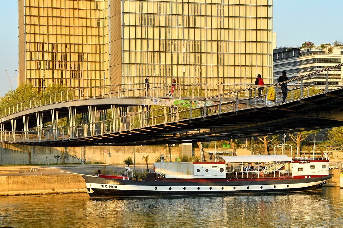 France, Paris, the banks of the Seine river, Bibliotheque Nationale de France (National Library of France) by architect Dominique Perrault and the Simone de Beauvoir footbridge by architect Dietmar Feichtinger\n