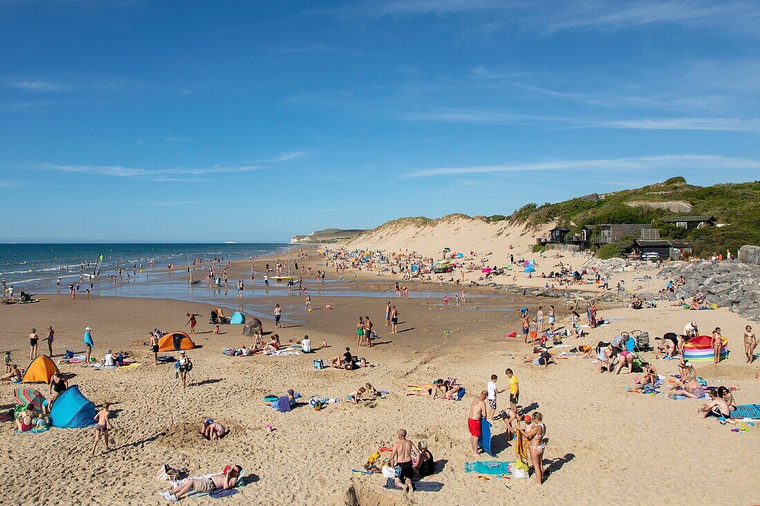 France, Pas de Calais, Wissant, Tourists on the beach with the Cape Blanc Nez in the background\n