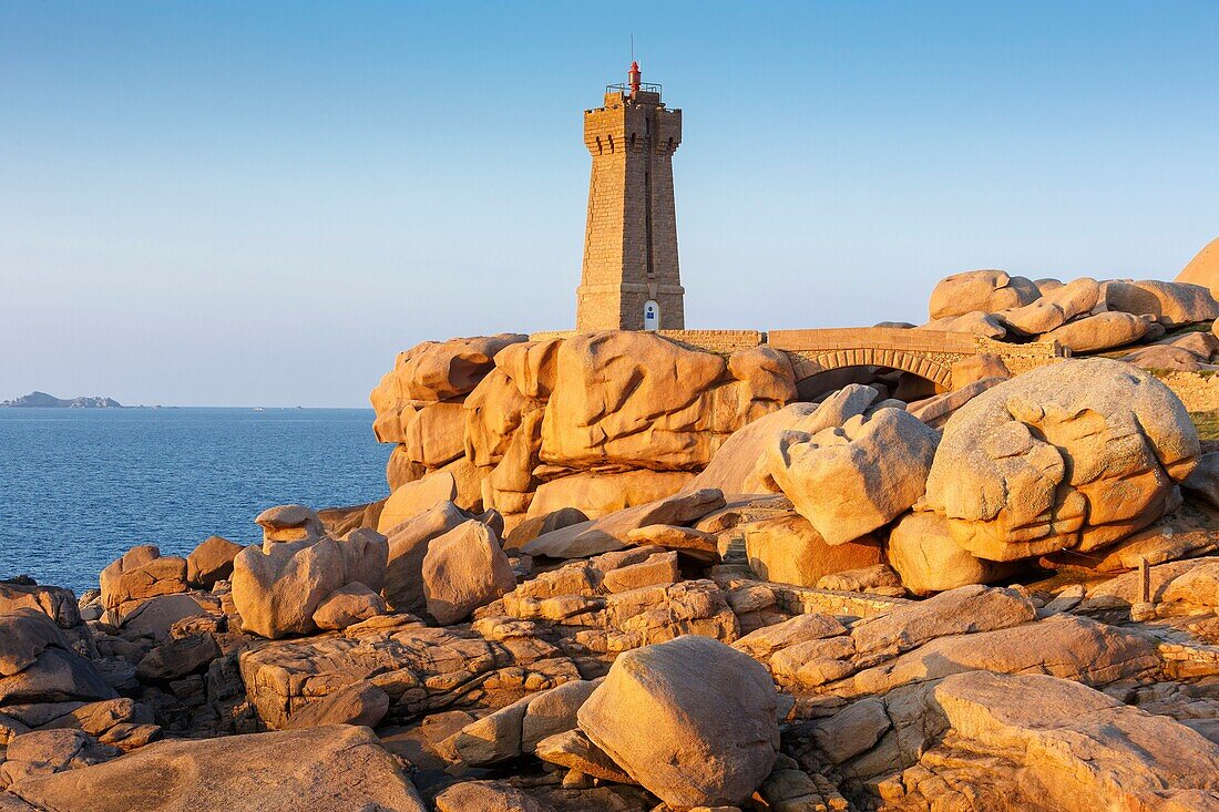 France, Cotes d'Armor, Pink Granite Coast, Perros Guirec, on the Customs footpath or GR 34 hiking trail, Ploumanac'h or Mean Ruz lighthouse at sunset\n