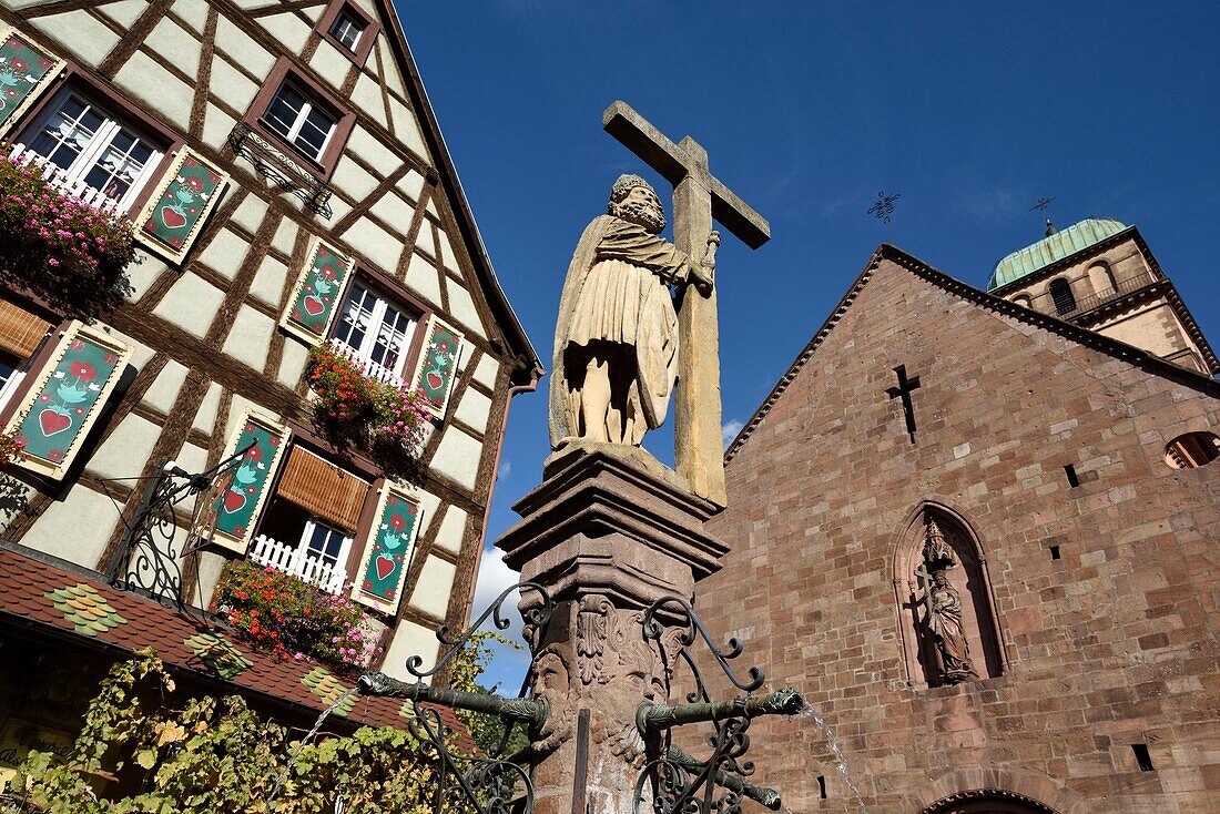 France, Haut Rhin, Kaysersberg, Place Jean Ittel, Sainte Croix church, portal dated 13th century, fountain Emperor Constantine 1521, half-timbered house\n