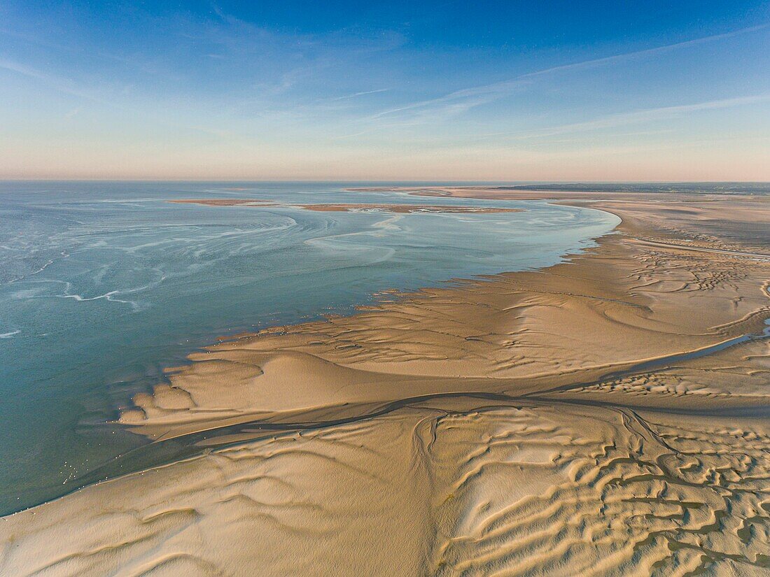 France, Somme, Baie de Somme, Le Crotoy, the Bay of Somme at low tide in the early morning, the nature reserve and the ornithological park of Marquenterre in the background (aerial view)\n