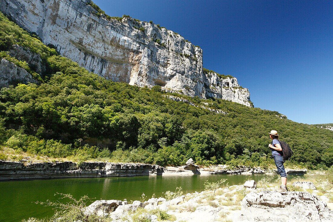 France, Ardeche, Sauze, Ardeche Gorges natural national reserve, Female hiker on the downstream path of the Ardeche Canyon, going from Gournier bivouac to Sauze\n