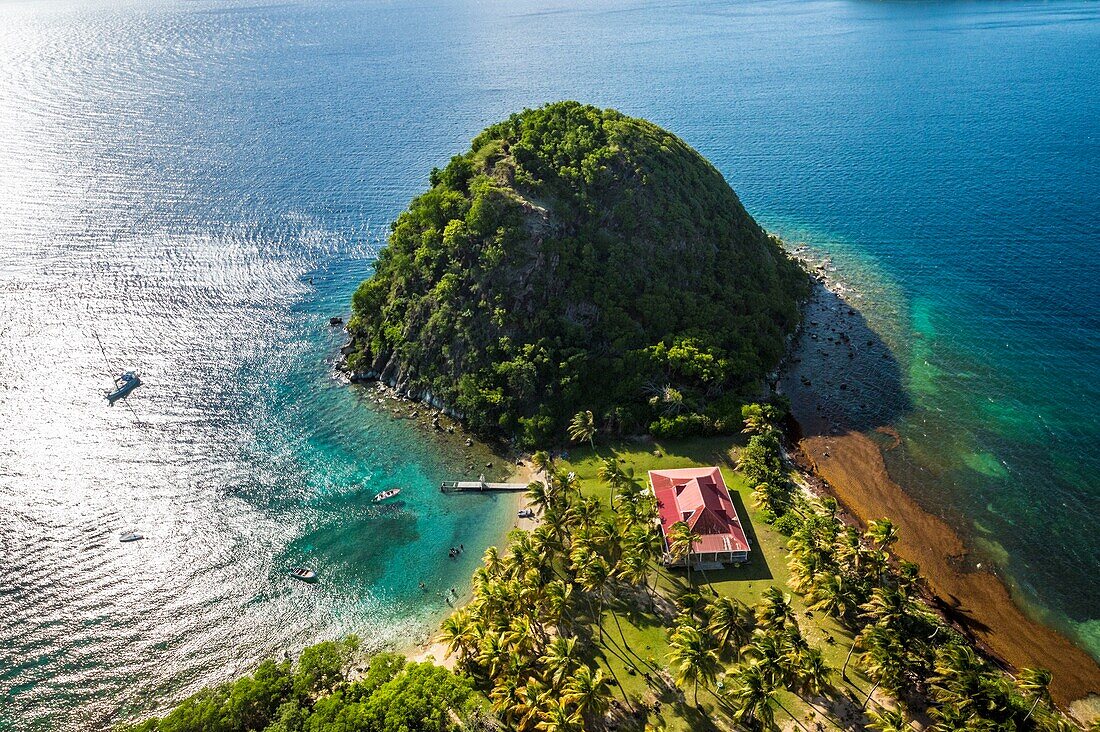 Guadeloupe, Les Saintes, Terre de Haut, the bay of the town of Terre de Haut, listed by UNESCO among the 10 most beautiful bays in the world, here the Pain de Sucre (aerial view)\n