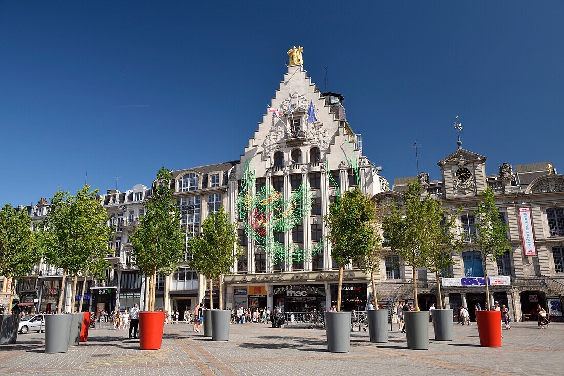 France, Nord, Lille, Place du General De Gaulle or Grand Place, façade of the Voix du Nord building with a drawing as part of the Lille 3000 Eldorado exhibition next to the Theater of the Nord\n