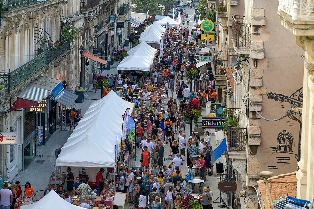 France, Herault, Sete, Alsace Lorraine Street, comes and goes from walking in a pedestrian street\n