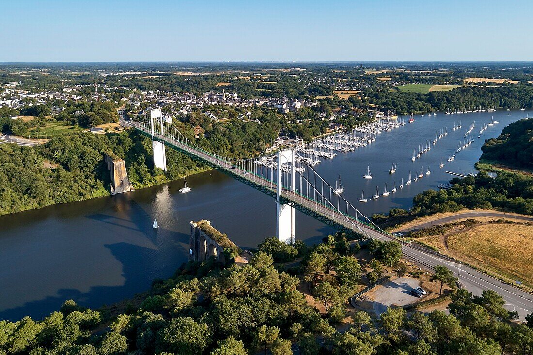 France, Morbihan, La Roche Bernard, suspended bridge over Vilaine river and the marina (aerial view)\n