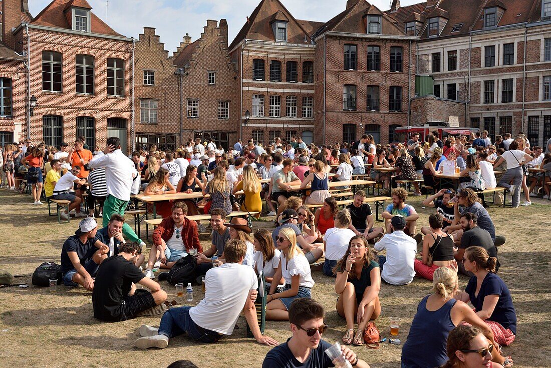 France, Nord, Lille, Vieux-Lille, Comtesse island, jumble sale 2019, walkers sitting in the grass or around tables\n