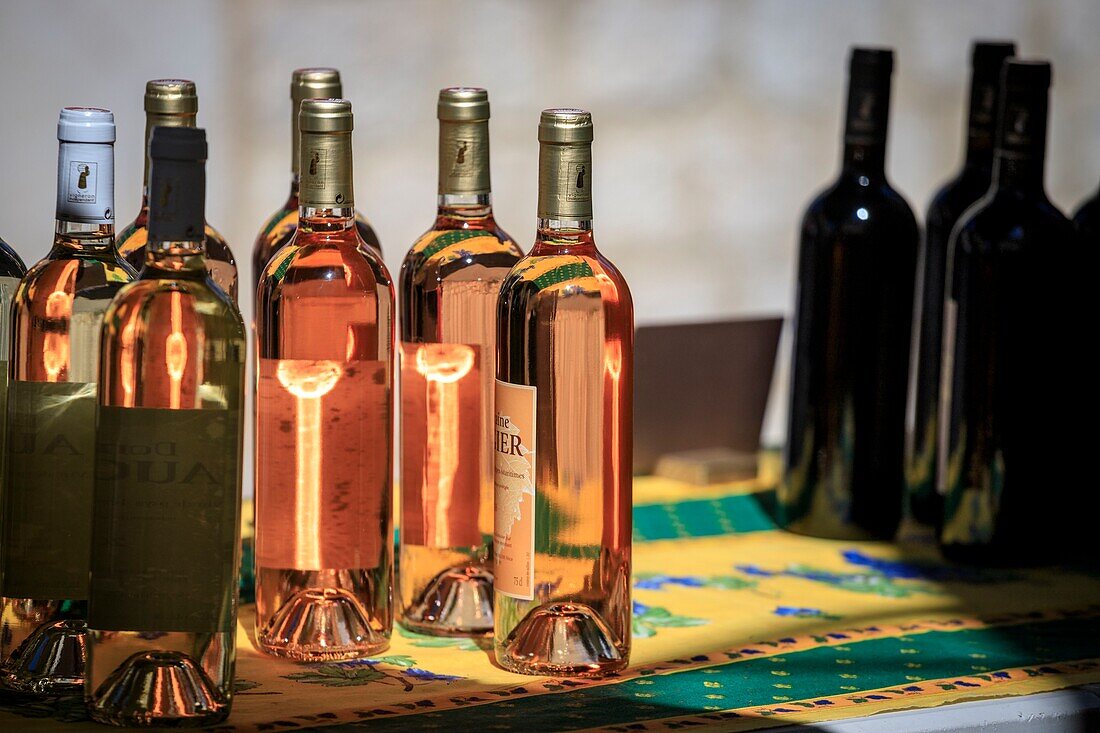 France, Alpes Maritimes, Parc Naturel Regional des Prealpes d'Azur, Gourdon, labeled Les Plus Beaux Villages de France, Farming party of Gorges du Loup, stall of bottles of rose wine and red wine from Domaine Augier\n