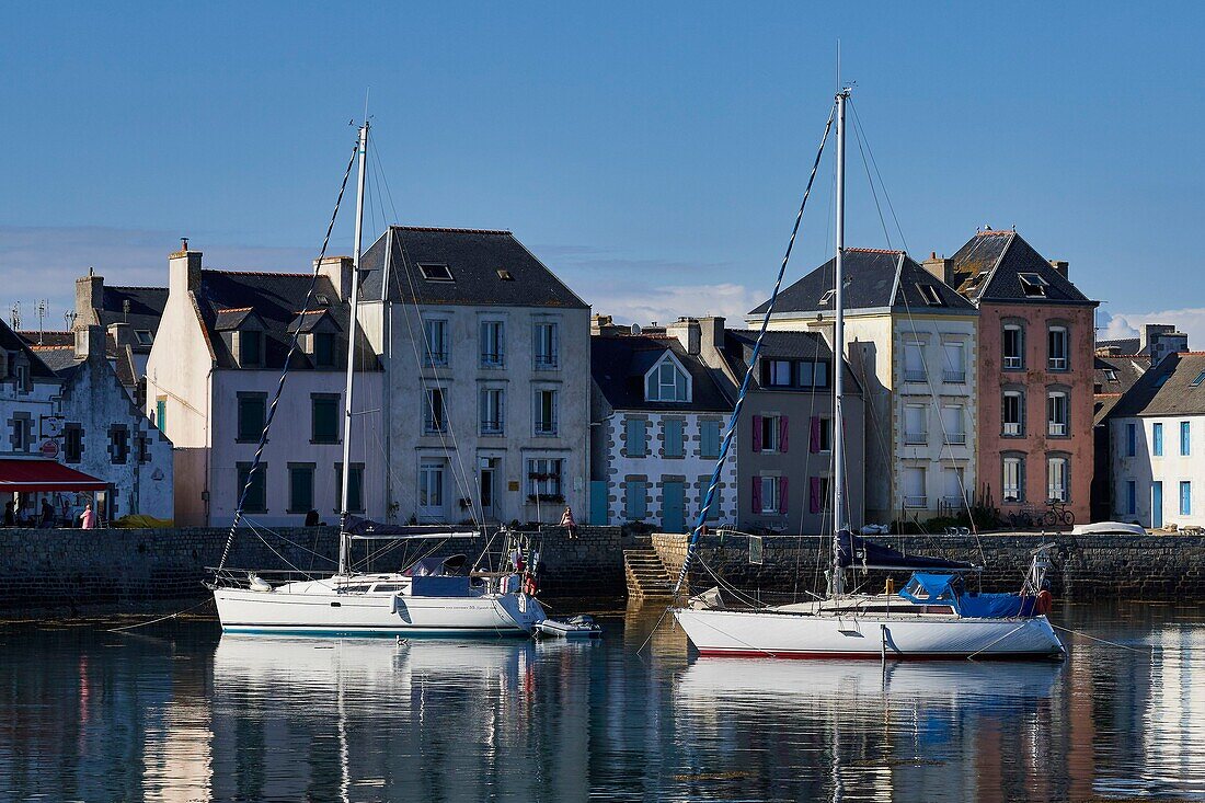 France, Finistere, Ile de Sein, sailboats at anchor in the port at high tide in front of the quai des Français Libres\n