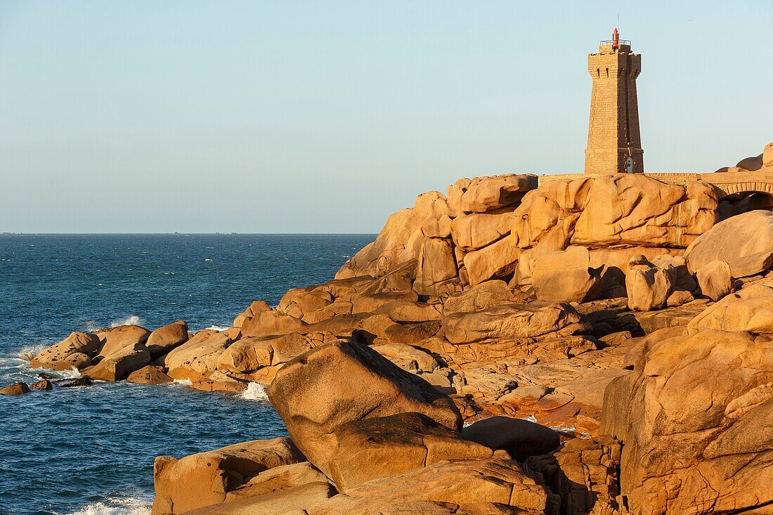 France, Cotes d'Armor, Pink Granite Coast, Perros Guirec, on the Customs footpath or GR 34 hiking trail, Ploumanac'h or Mean Ruz lighthouse at sunset\n