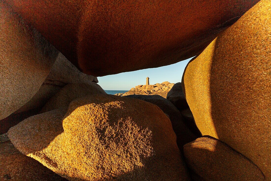 France, Cotes d'Armor, Pink Granite Coast, Perros Guirec, on the Customs footpath or GR 34 hiking trail, Ploumanac'h or Mean Ruz lighthouse at sunset\n