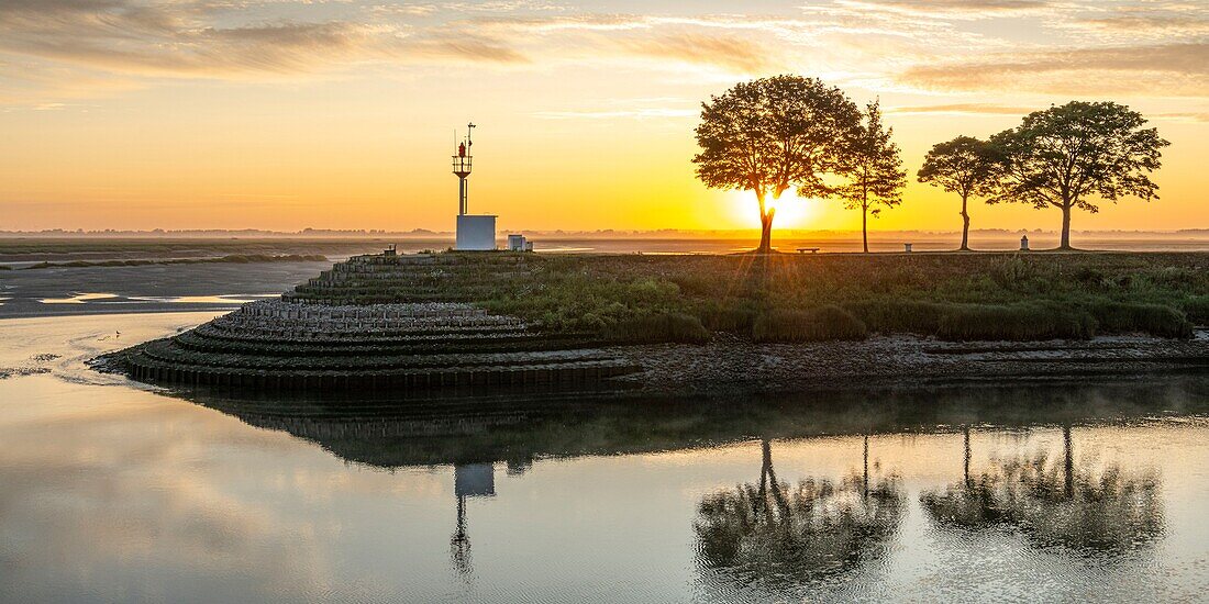 France, Somme, Somme Bay, Natural Reserve of the Somme Bay, Saint Valery sur Somme, the quays along the channel of the Somme in the early morning with the boats used by hunters to cross the river\n