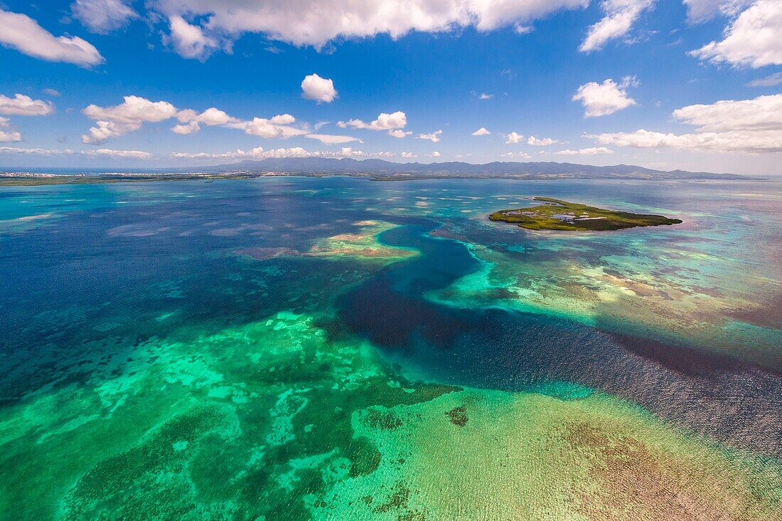 France, Caribbean, Lesser Antilles, Guadeloupe, Grand Cul-de-Sac Marine, heart of the Guadeloupe National Park, Basse-Terre, aerial view of the Fajou Island pass and the longest coral reef (25 km) of the Lesser Antilles, Biosphere Reserve of the Archipelago of Guadeloupe, La Soufrière volcano chain cleared in the background\n