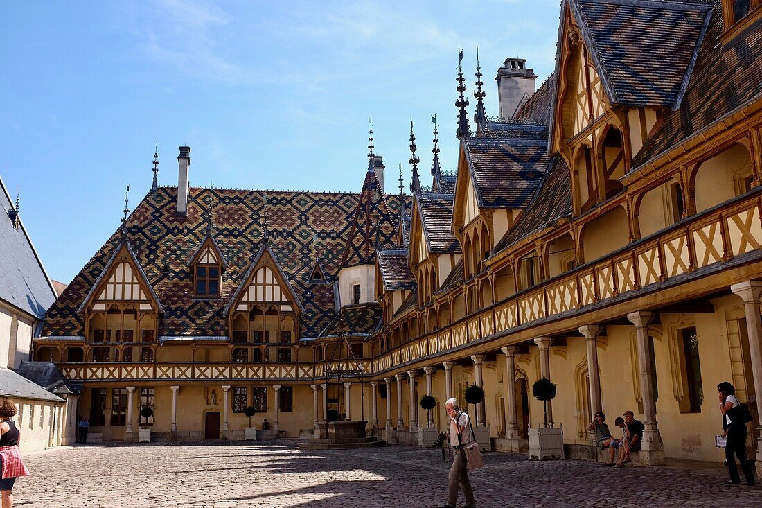 France, Cote d'Or, Beaune, Burgundy climates listed as World Heritage by UNESCO, Hospices de Beaune, Hotel Dieu, roof in varnished tiles multicolored in courtyard\n