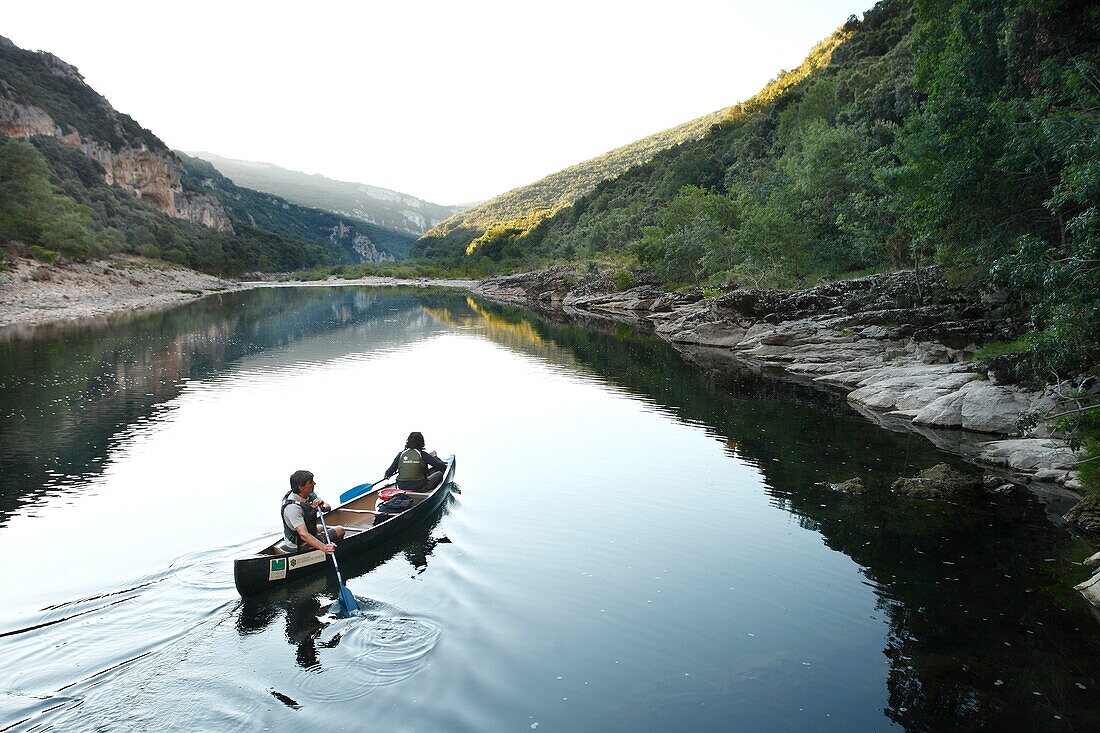 France, Ardeche, Ardeche Gorges National Natural Reserve, Sauze, a gard of the natural reserve makes its morning watch on a canoe in the Ardeche canyon\n