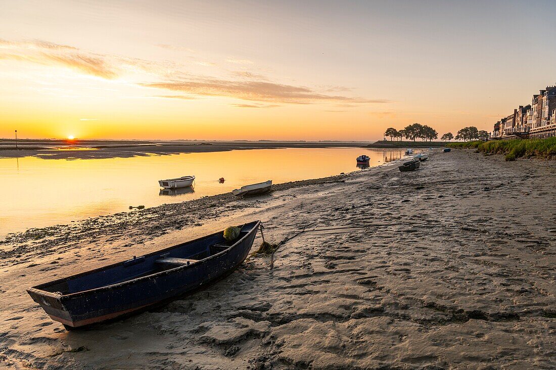 France, Somme, Somme Bay, Natural Reserve of the Somme Bay, Saint Valery sur Somme, the quays along the channel of the Somme in the early morning with the boats used by hunters to cross the river\n