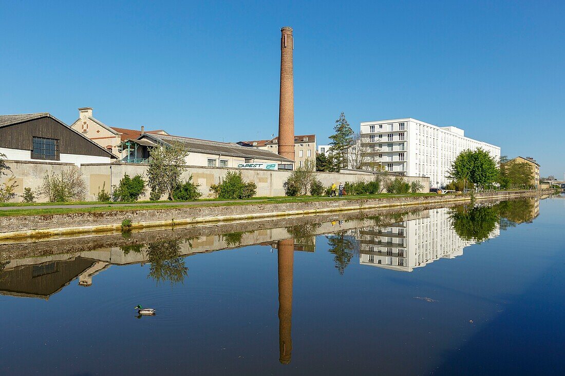 France, Meurthe et Moselle, Nancy, apartment buildings on the Meurthe canal and red bricks chimney\n