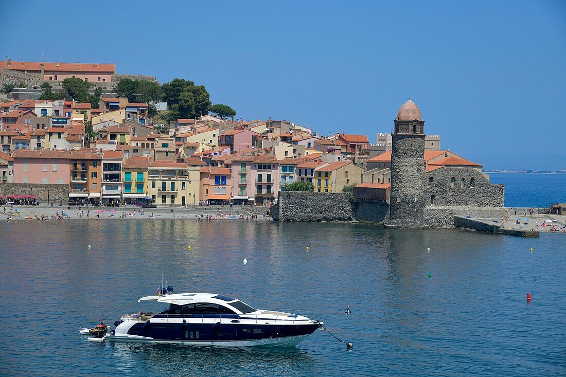 France, Pyrenees Orientales, Collioure, panorama on the beach of Boramar with the church of Notre Dame des Anges of the 17th century and a boat in the foreground\n