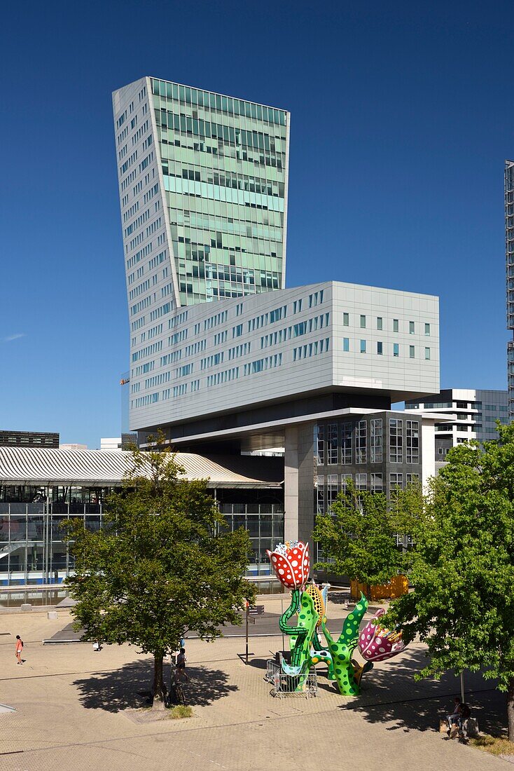 France, Nord, Lille, esplanade Place François Mitterrand with the Euralille business district which includes the Eurostar station and the Lille Europe TGV station, the Lille tower and the work entitled Les Tulipes de Shangri-La, permanent sculpture of Yayoi Kusama\n