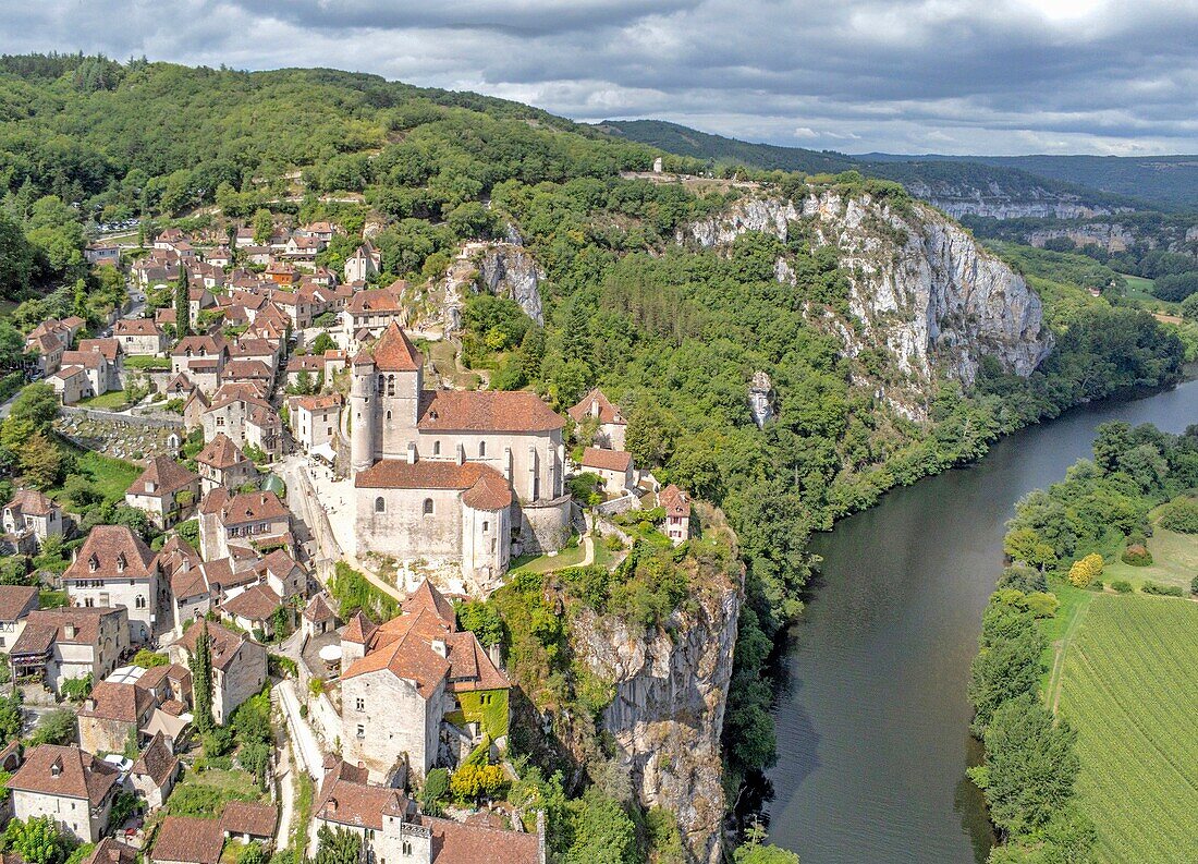 France, Lot, Parc Naturel Regional des Causses du Quercy, Saint Cirq Lapopie, labelled Les Plus Beaux Villages de France (The Most Beautiful Villages of France), the village perched on a cliff over the Lot river (aerial view)\n