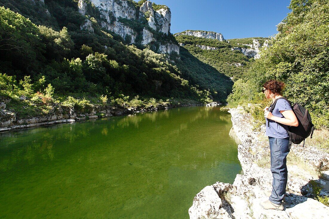 France, Ardeche, Sauze, Ardeche Gorges natural national reserve, Female hiker on the downstream path of the Ardeche Canyon, going from Gournier bivouac to Sauze\n