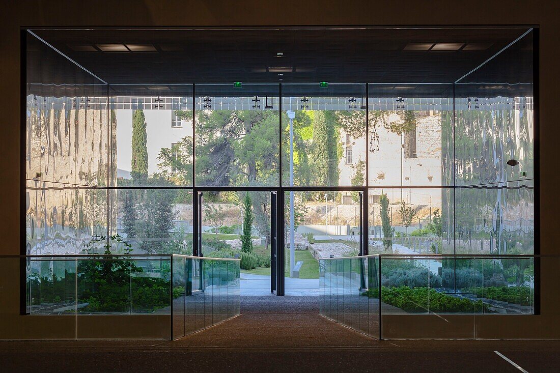 France, Gard, Nimes, Musee de la Romanite by architect Elizabeth de Portzamparc, gardens of romanite seen from the covered walkway\n