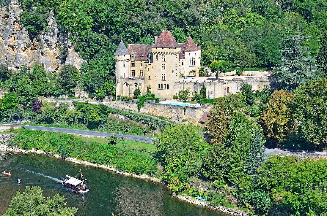 France, Dordogne, Perigord Noir, Dordogne Valley, La Roque Gageac, labelled Les Plus Beaux Villages de France (The Most Beautiful Villages of France), gabarre on Dordogne river and Chateau de La Malartrie\n