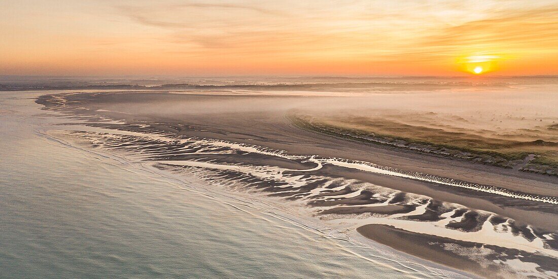 "France, Somme, Bay of Authie, Fort-Mahon, the dunes of Marquenterre at sunrise while the mist still nestles between the dunes; view between Fort Mahon and Authie Bay"\n