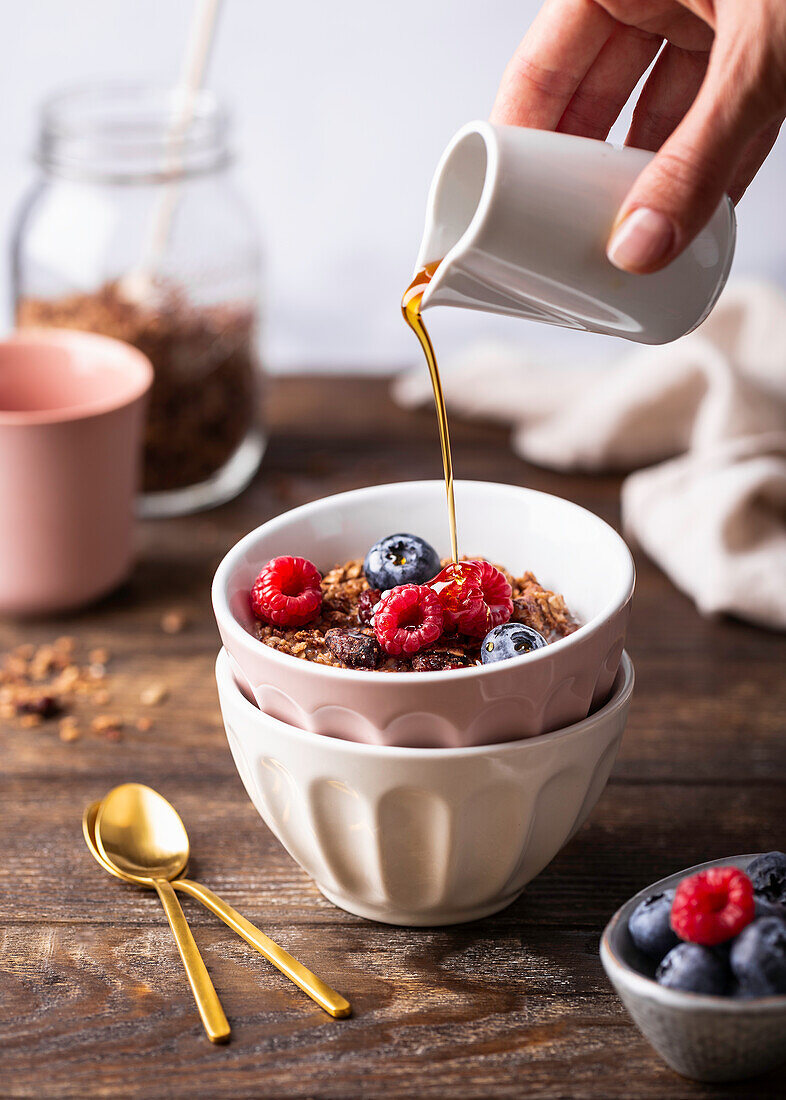 Breakfast muesli with fresh berries and maple syrup