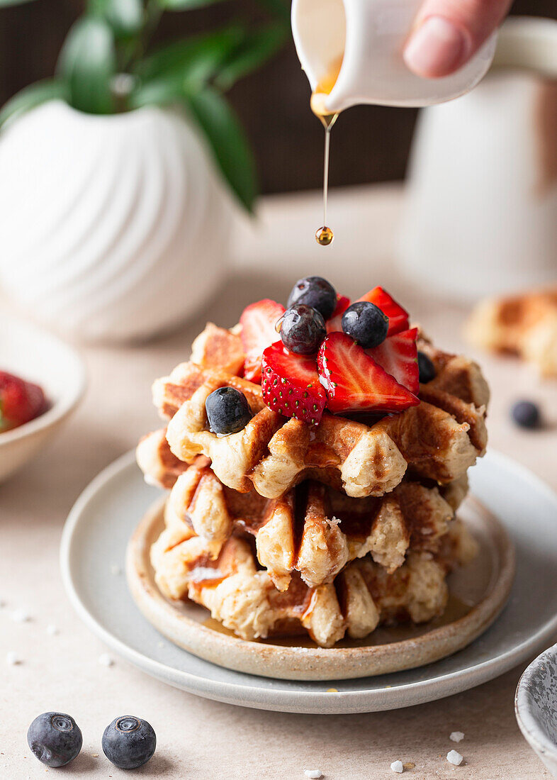 Belgian waffles with maple syrup and berries