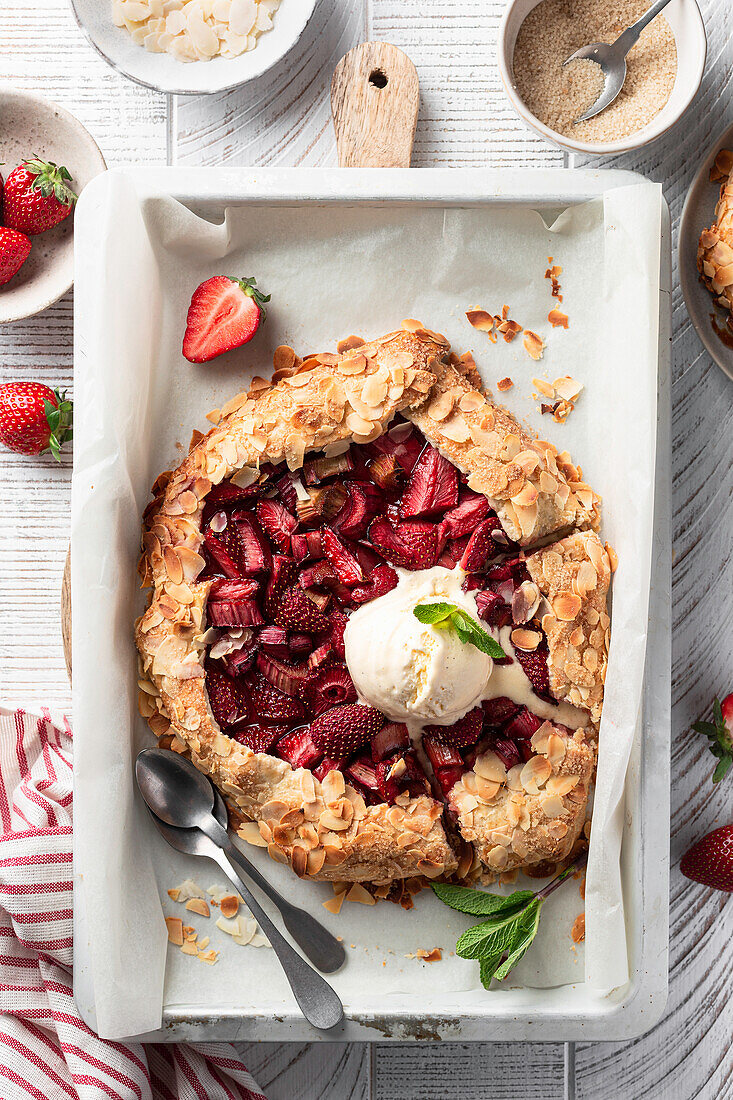 Strawberry and rhubarb galette with almonds and vanilla ice cream