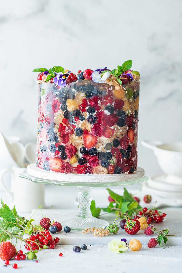 Cake decorated with summer berries, covered with jelly