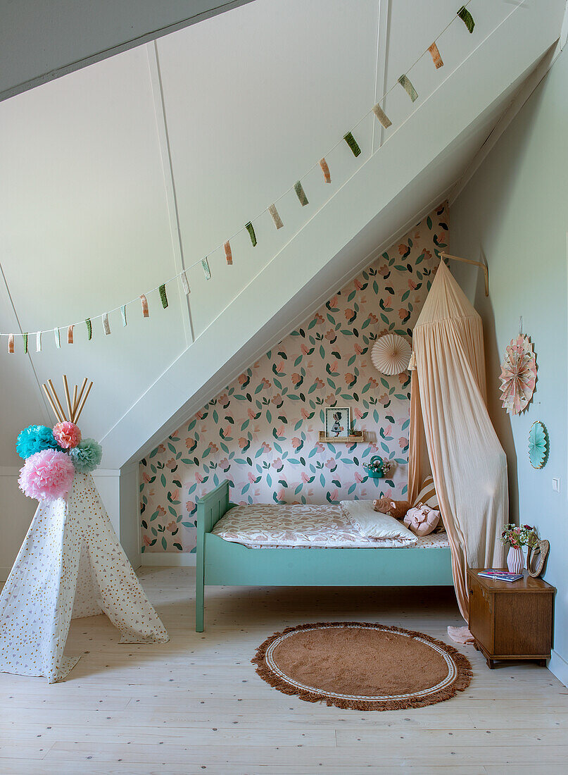 Children's room with bed, canopy and tent under a sloping roof